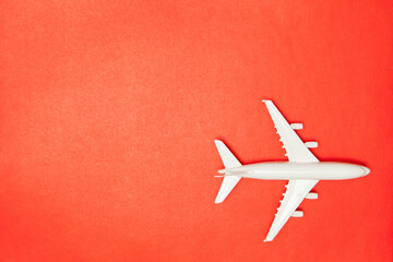 Airplane model. White plane on red background. Travel vacation concept. Summer background. Flat...