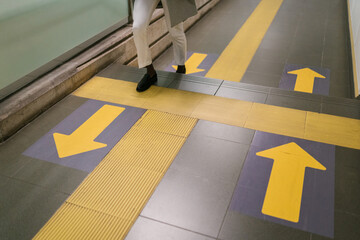 Crop man walking upstairs at subway station
