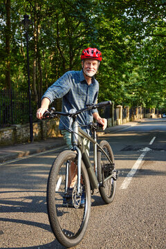 Older Man posing with Mountain bike
