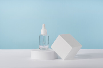 Serum cosmetic bottle with peptides and retinol on platform pedestal on blue background. Oil...