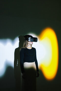 Girl using metaverse equipment in studio 