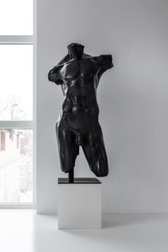 Antique sculpture on metal base in studio