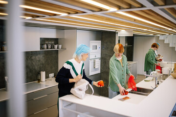 Females unpacking purchases from bags