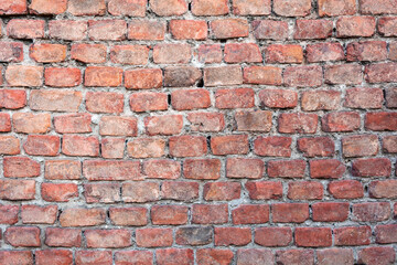 Fototapeta premium Background wall of red bricks. Wallpaper, texture of shabby bricks.