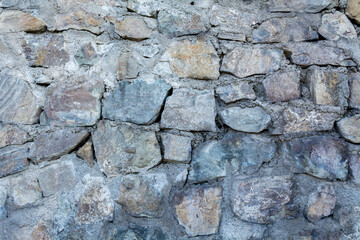 Background wall of stone. Wallpaper large cobblestones.