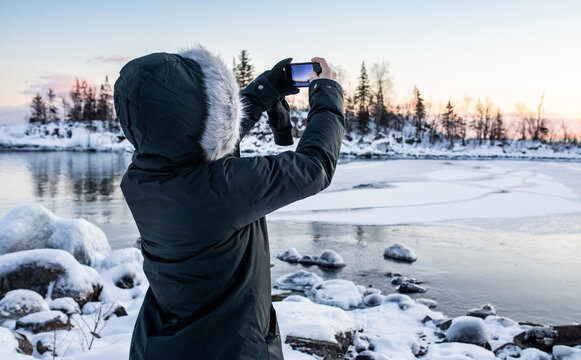 Woman taking photo of Lake Superior with phone 2