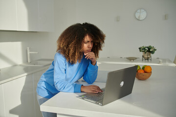 Portrait of smiling biracial female self employed freelancer at work using laptop
