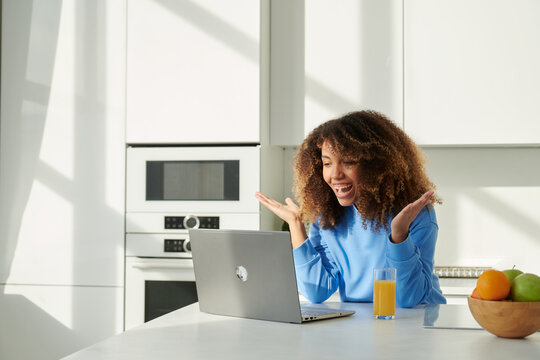 Young african american woman talking on video at home