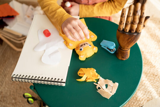 Child making tissue puppets tabletop