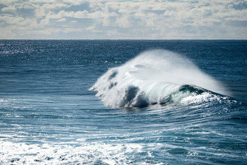 Scenic view of the deep blue Atlantic Ocean and a beautiful wave crashing on the coast of Paul do...