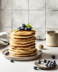 Stack of pancakes with fresh blueberry and honey
