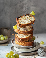Delicious homemade fruit cake with raisins in levitation with crumbling powdered sugar