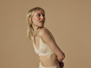 cheerful model looks aways with a glowing and healthy skin 