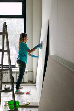 Portrait of woman plasterer at work 