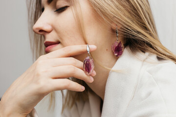 woman wearing floral epoxy earrings