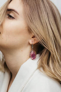 woman wearing floral epoxy earrings  