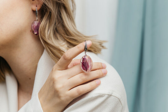 woman wearing floral epoxy earrings  