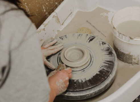 artesian creates on pottery wheel