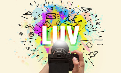 Close-up of a hand holding digital camera with abstract drawing