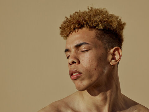 confident young men portrait - natural afro hair - acne skin 