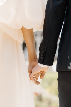 anonymous bride and groom holding hands