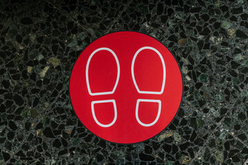 Red sign of feet for social distancing