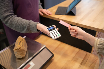 Crop woman paying for purchase in zero waste store