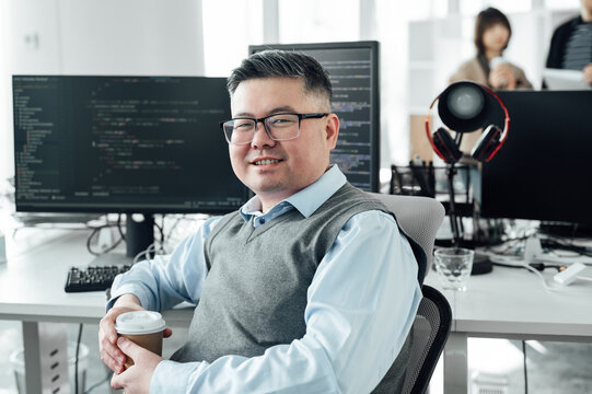 Portrait of Chinese male engineer with computer in office