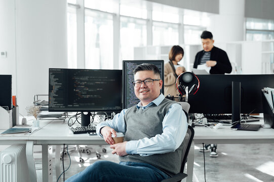 Portrait of Chinese male engineer with computer in office