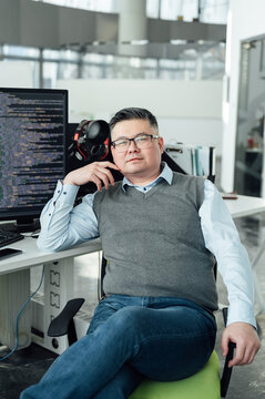 Portrait of Chinese male engineer with computer in office