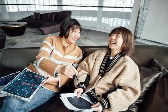 Two casual businesswoman talking in office