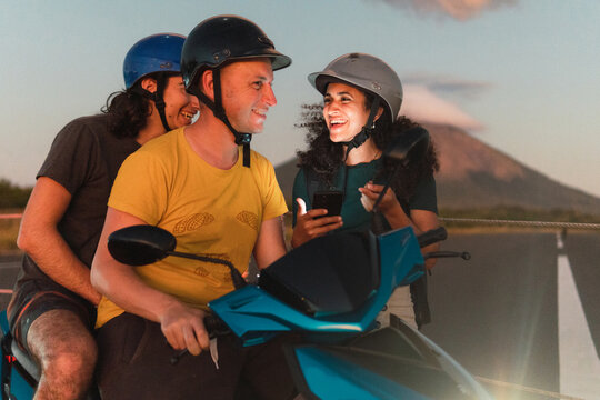 Woman asking a couple on a motorbike