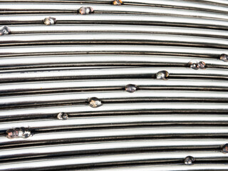 Silver metal in pattern line welding dots close up.