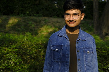 Portrait of a young boy just touched adulthood at outdoors in daylight