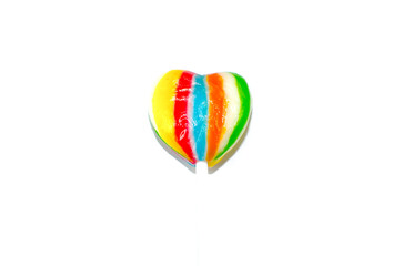 Single heart shaped lollipop in rainbow color isolated on white background.