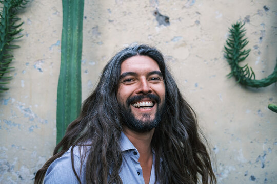 portrait of long-haired man with gray hair and beard 