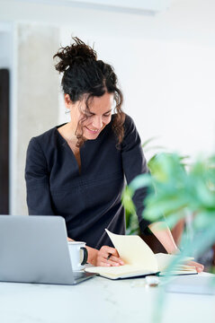 Optimistic businesswoman reading notes