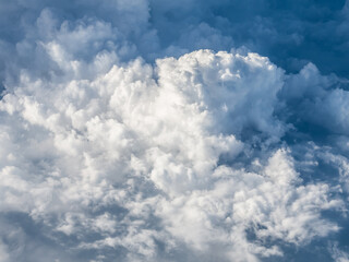 Fluffy stratus cloud from an aircraft window.