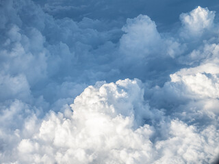 Naklejka na ściany i meble Fluffy stratus cloud from an aircraft window.