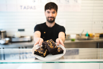 Blurred male waiter giving order coffee shop