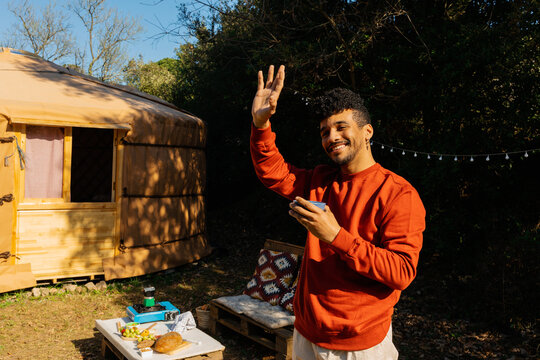 Joyful man  Waving hello Outdoors