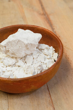 Lime stone in a clay bowl on a wooden table