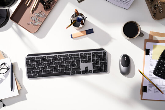 Keyboard and coffee cup arranged with office tools