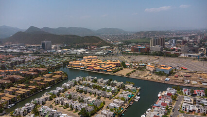 Photos from an aerial view of a drone, of a beach on a cloudy day from different angles and places, the tone of the photos is warm, in the photos you can see vegetation, trees, bushes, grass, sand, sk