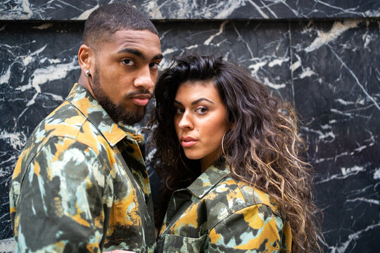 Portrait Of A Multiracial Couple With Military Clothes.