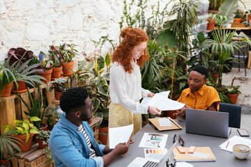 Diverse designers working with papers together