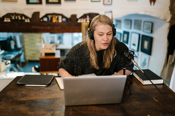 Woman talking in mic and recording podcast