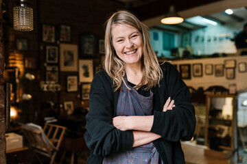 Glad female painter in apron in workshop