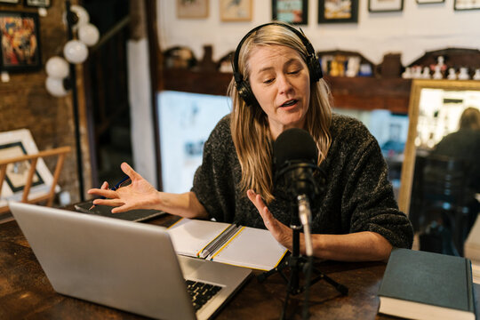Radio host recording podcast and gesticulating