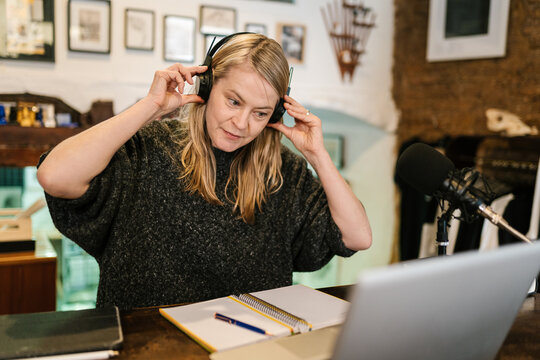 Woman in headset preparing for recording podcast